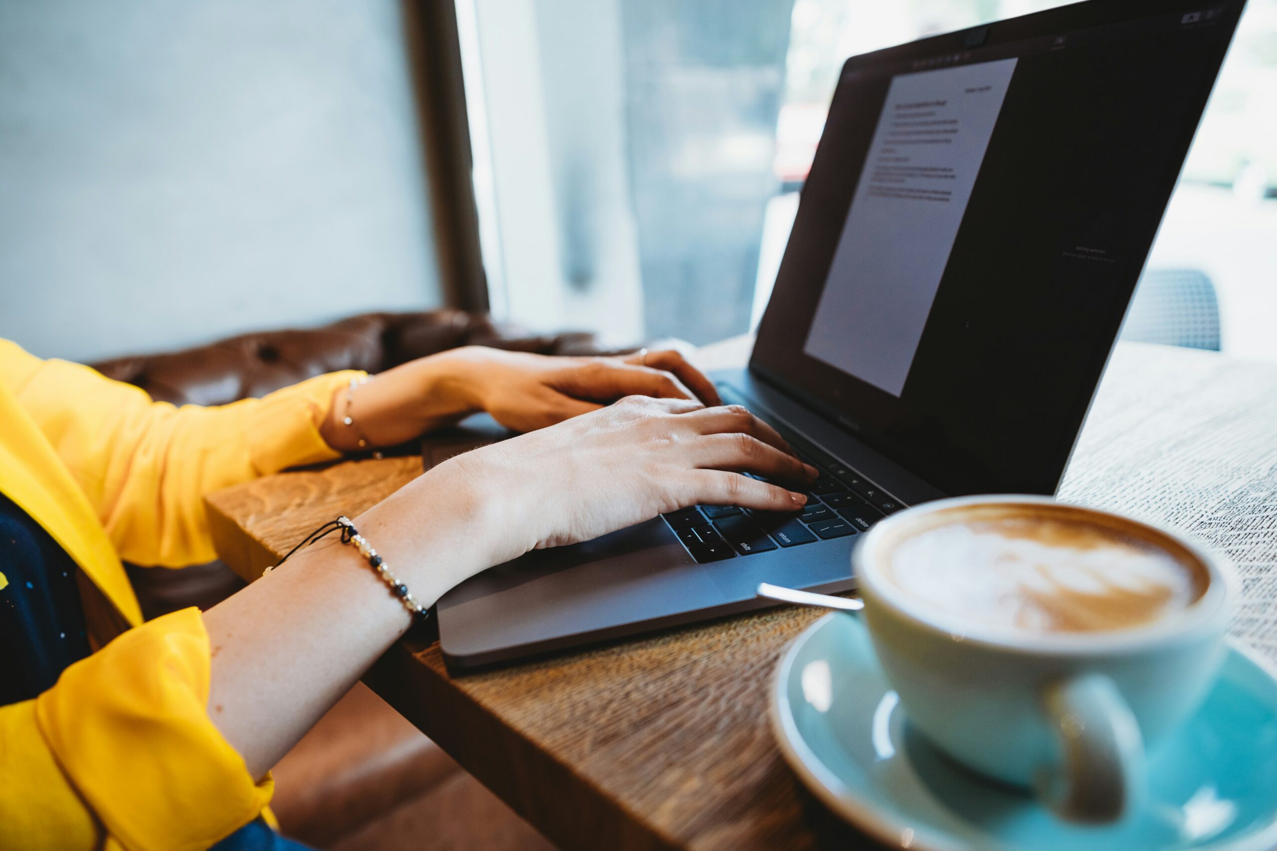 Freelance content creator working at home desk with laptop